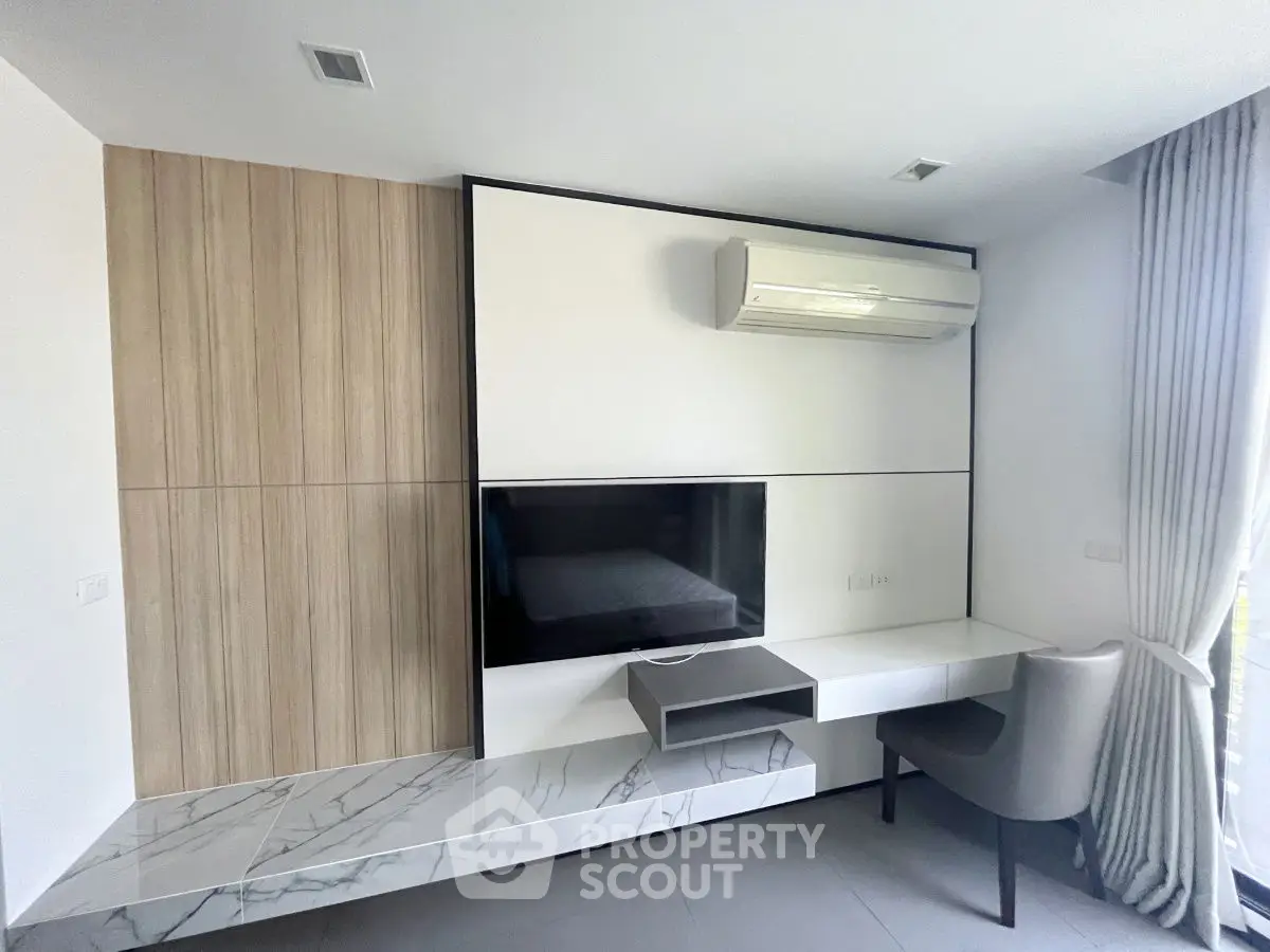 Modern living room with wall-mounted TV and air conditioning