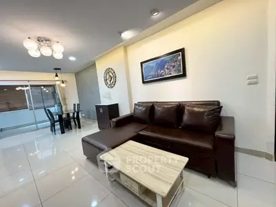 Spacious living room with modern decor and elegant lighting in a stylish apartment.