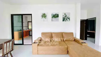 Spacious living room with modern decor and comfortable seating in a stylish home.