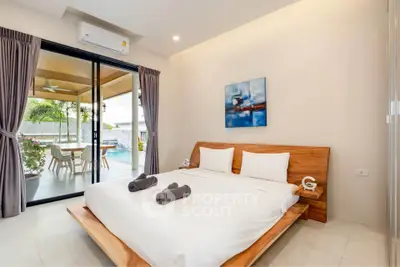 Luxurious bedroom with pool view and modern decor in tropical villa