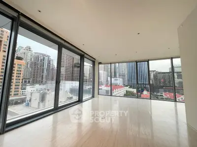 Spacious corner unit with floor-to-ceiling windows offering stunning city views.