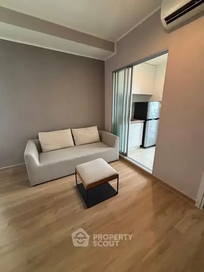 Modern living room with sleek sofa and open kitchen view