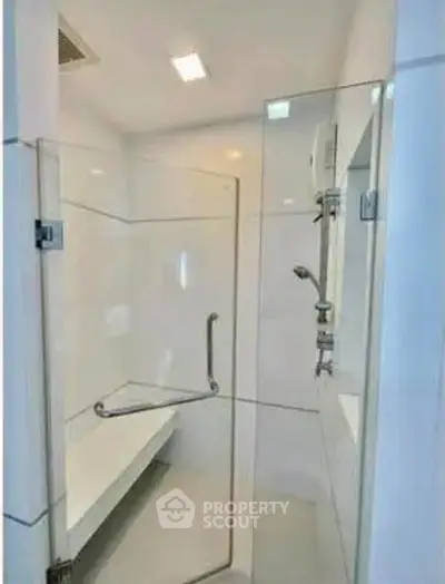 Modern bathroom with glass shower enclosure and sleek fixtures