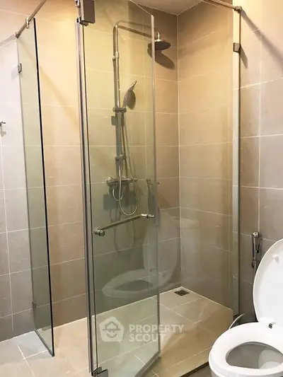 Modern bathroom with glass shower enclosure and sleek fixtures