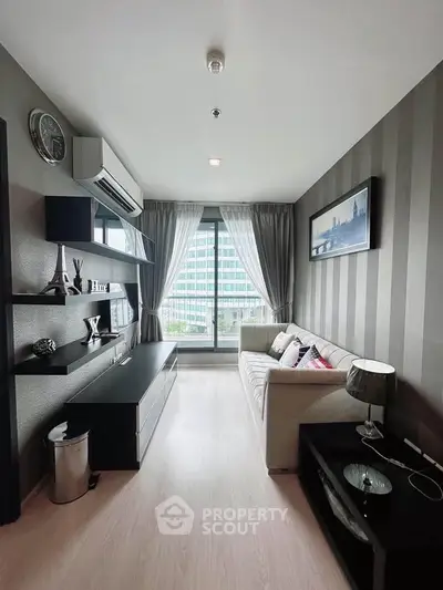 Modern living room with stylish decor and large window offering city view