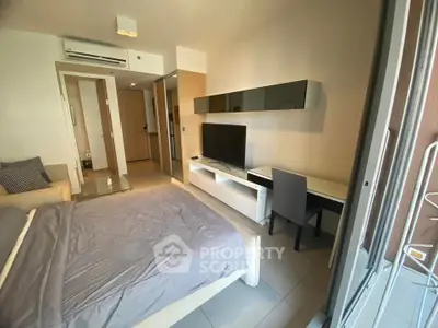 Modern bedroom with sleek furniture and workspace in a stylish apartment