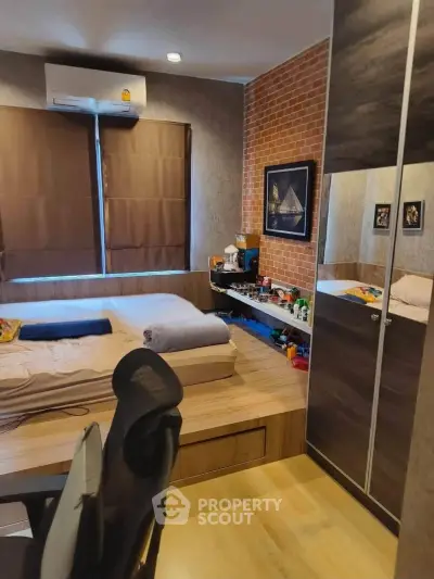 Modern bedroom with stylish brick accent wall and cozy workspace