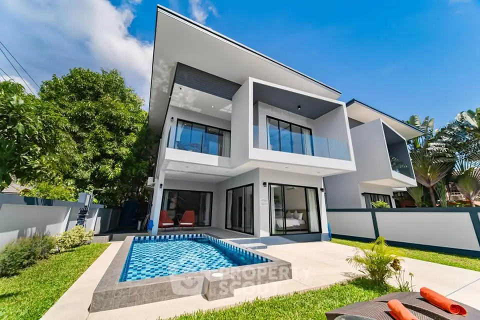 Modern luxury villa with private pool and spacious balconies in tropical setting.