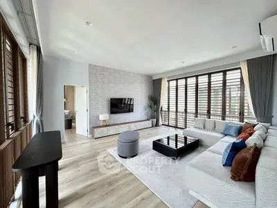 Spacious modern living room with large windows and stylish decor