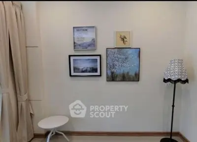 Cozy corner with elegant wall art and stylish floor lamp