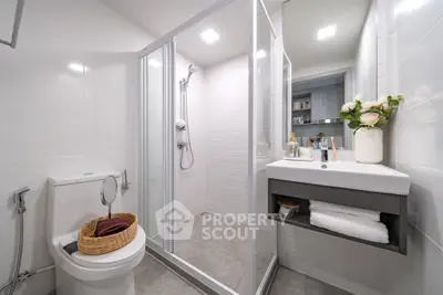 Modern bathroom with glass shower and sleek fixtures, perfect for a contemporary home.