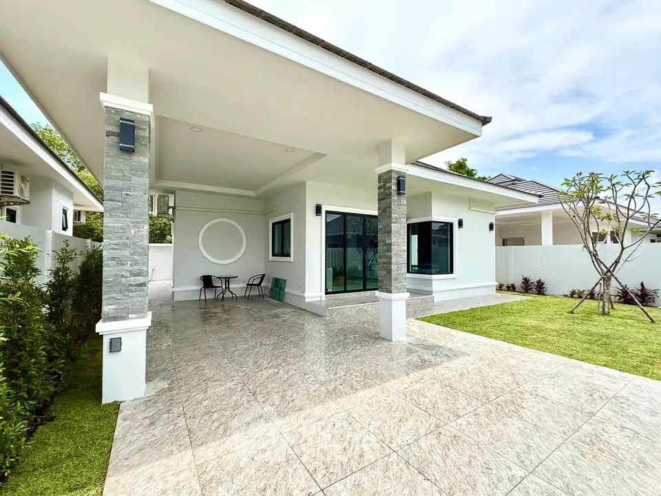 Modern single-story home with spacious patio and lush garden, perfect for outdoor living.