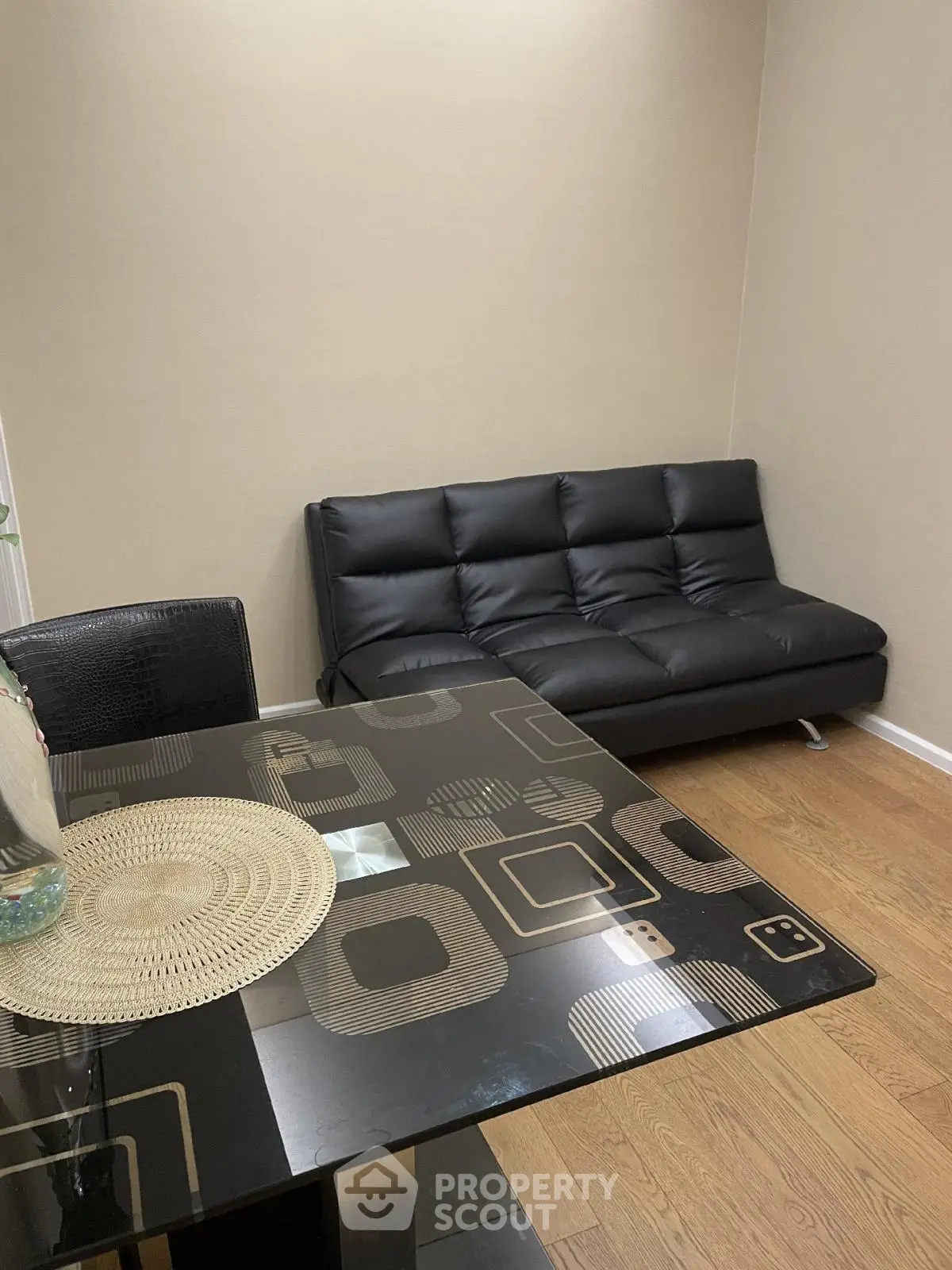Modern living room with sleek black sofa and stylish dining table