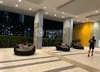 Modern building entrance with stylish seating and ambient lighting at night