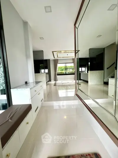 Spacious modern living room with large mirror and elegant decor
