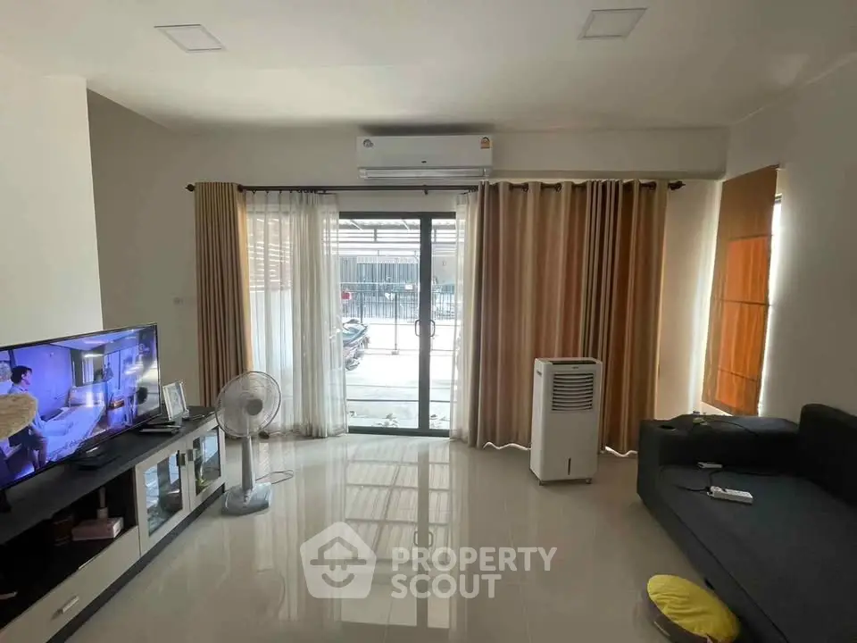 Spacious living room with modern decor and large windows for natural light.