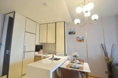Modern kitchen with sleek cabinetry and elegant lighting in a stylish apartment.