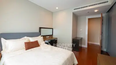 Spacious bedroom with modern decor and wooden flooring
