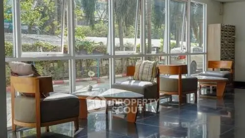 Bright and inviting lobby area with modern seating and large windows overlooking greenery.
