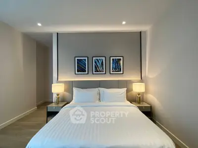 Modern bedroom with elegant decor and cozy lighting in a stylish apartment.