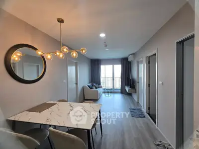 Modern living room with stylish dining area and elegant lighting