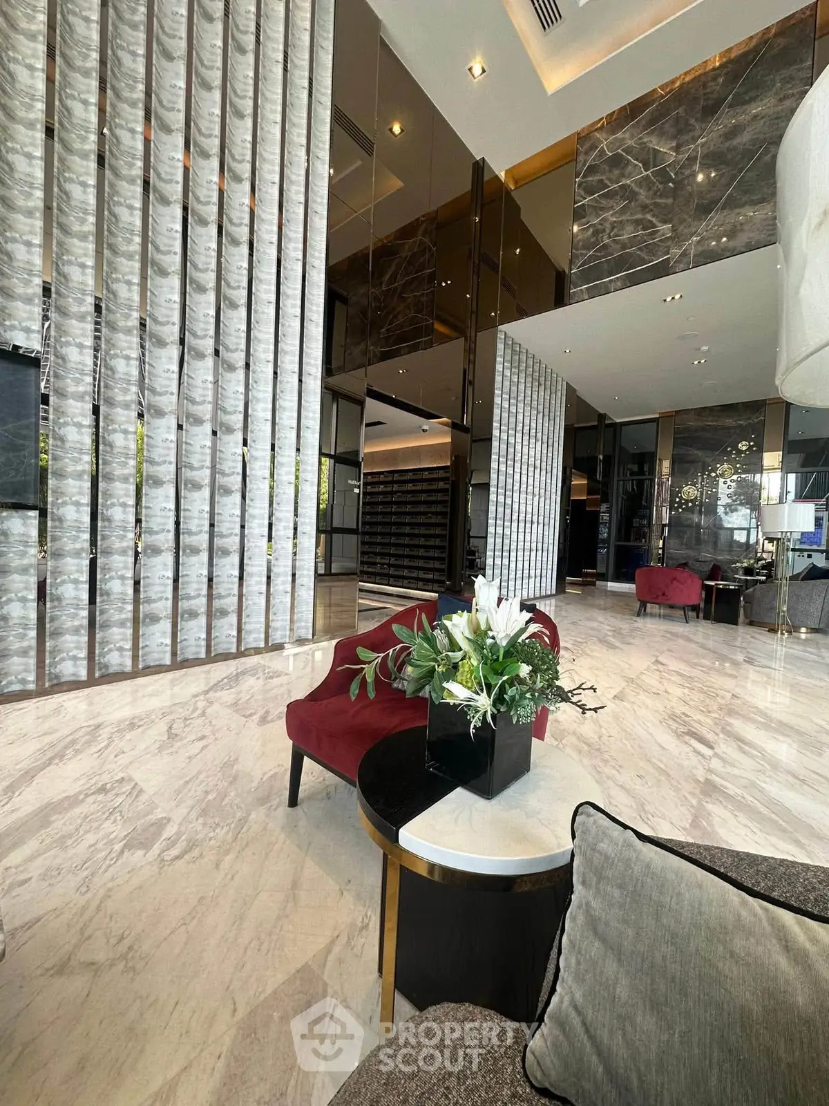 Luxurious modern lobby with elegant marble flooring and stylish decor in a high-end residential building.