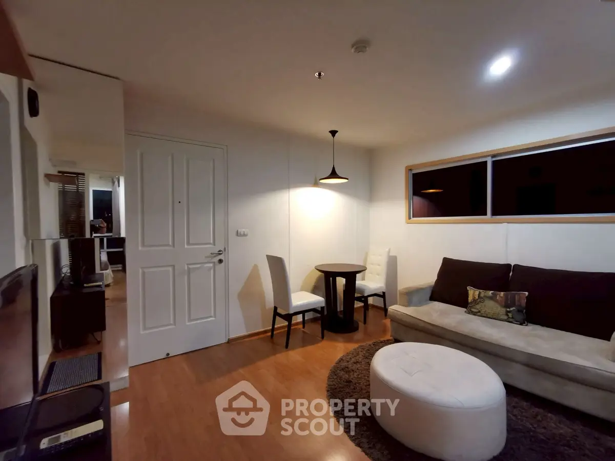 Cozy living room with modern furniture and warm lighting, perfect for relaxation and entertainment.