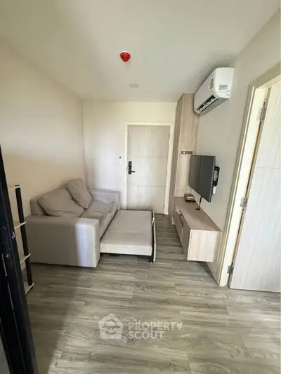 Modern living room with sleek furniture and air conditioning in a cozy apartment.