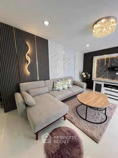 Modern living room with stylish decor, featuring a plush sofa, elegant lighting, and a chic coffee table.