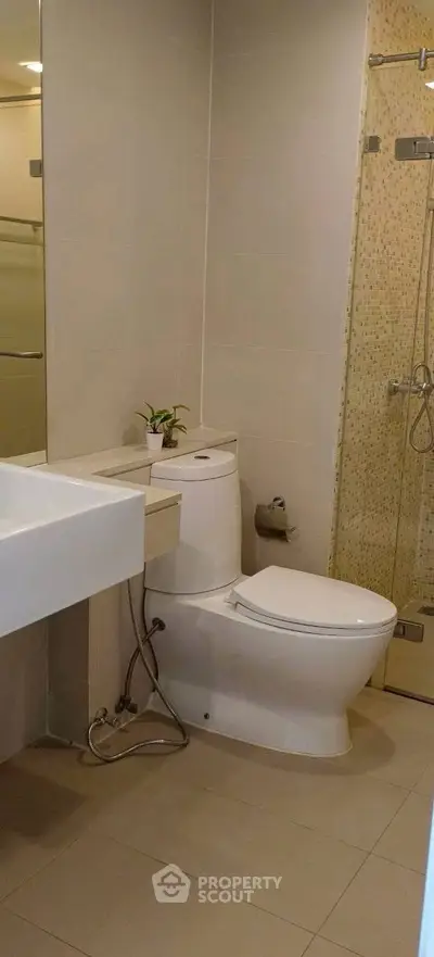 Modern bathroom with sleek fixtures and glass shower enclosure