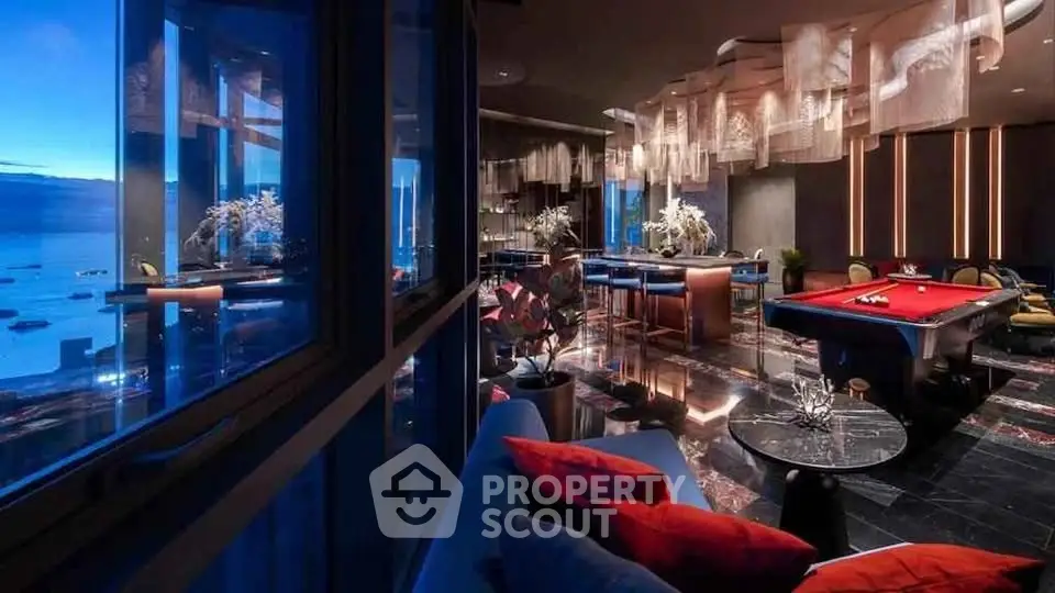 Luxurious modern living room with pool table and stunning ocean view, perfect for entertainment and relaxation.