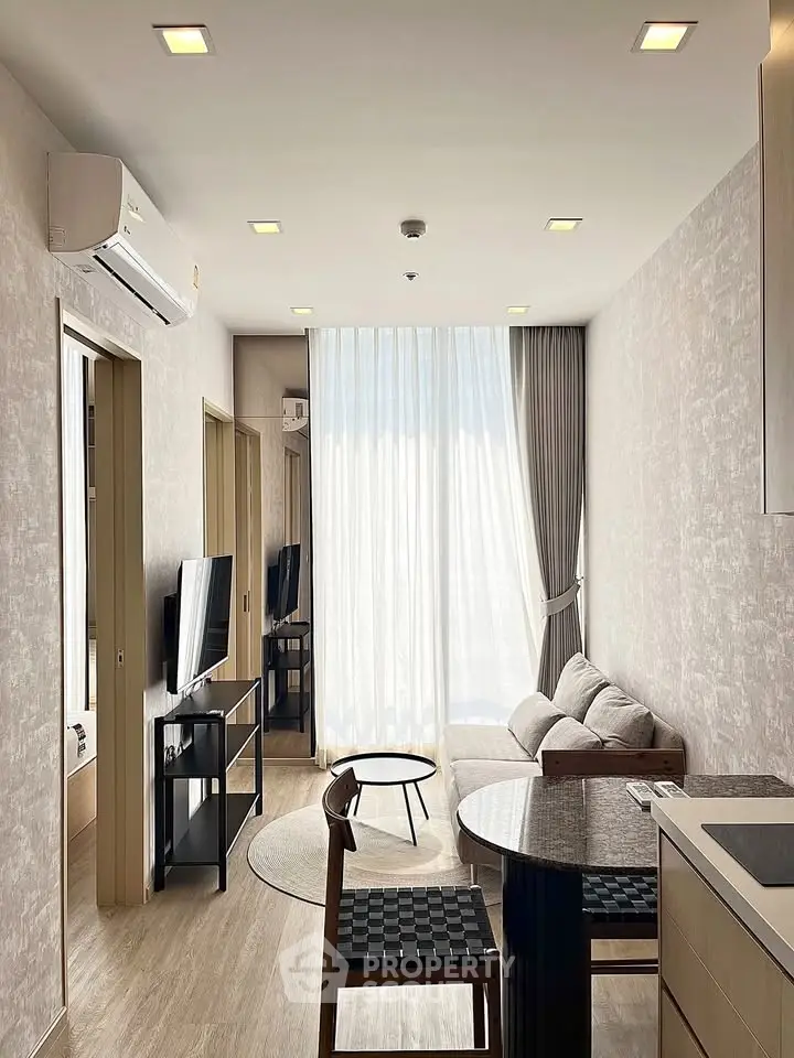 Modern living room with stylish furniture and natural light, featuring a cozy sofa and elegant decor.