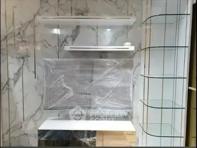Modern kitchen with marble backsplash and sleek shelving