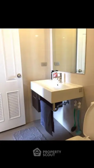 Modern bathroom with sleek sink and mirror in a stylish home.