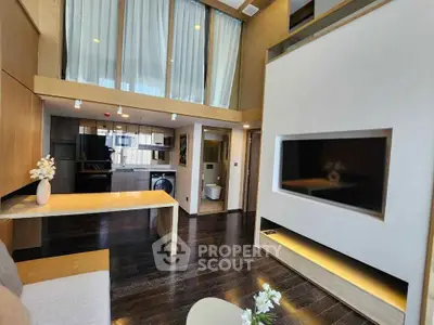 Modern living room with high ceilings and sleek wooden finishes, featuring a large TV and stylish decor.