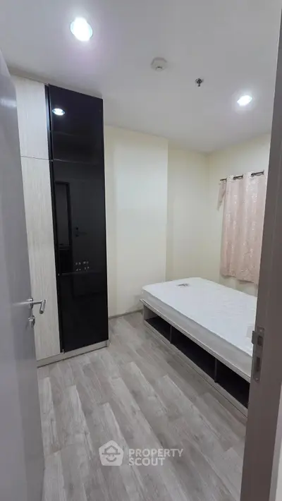 Modern bedroom with sleek wardrobe and minimalist design, perfect for urban living.