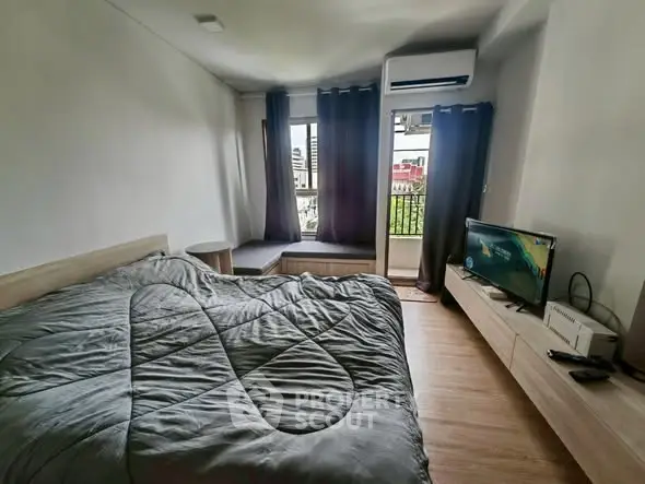 Cozy bedroom with modern furnishings and city view balcony