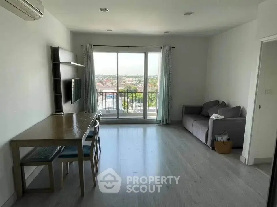 Spacious living room with balcony and scenic view in modern apartment