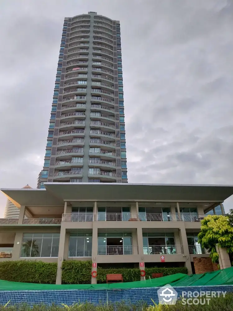 Modern high-rise building with lush landscaping and spacious balconies