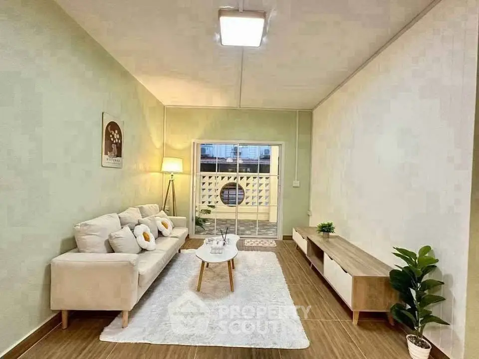 Charming living room with cozy sofa, stylish decor, and natural light in modern apartment.