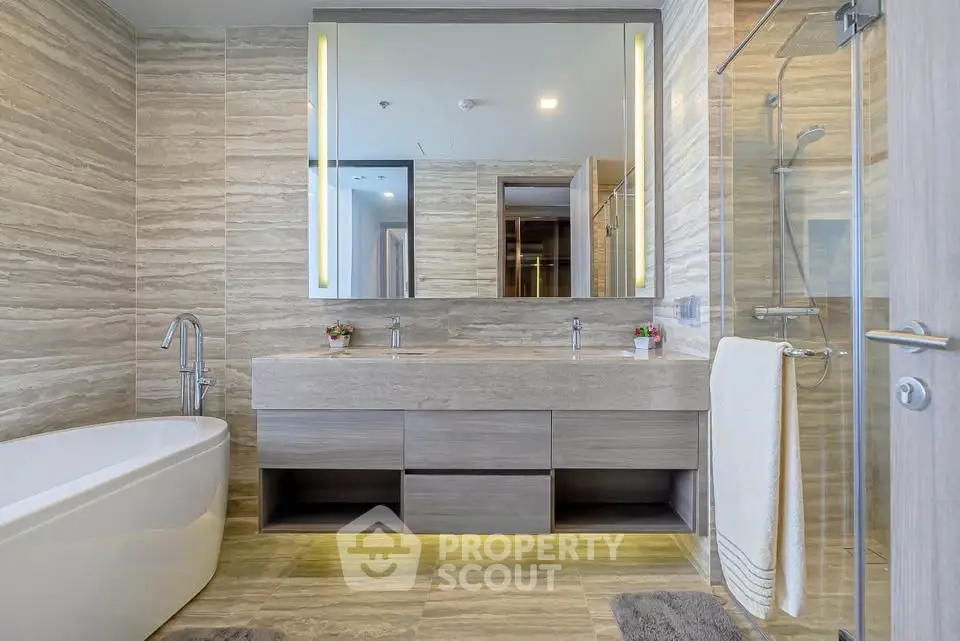 Luxurious modern bathroom with elegant bathtub and spacious shower area.
