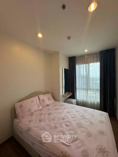 Cozy bedroom with large window and soft lighting, perfect for relaxation.