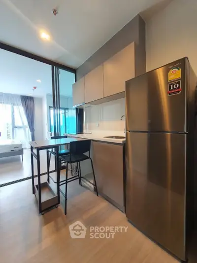 Modern kitchen with sleek appliances and open layout in stylish apartment