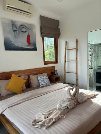 Cozy bedroom with stylish decor and natural light, featuring a wooden bed and elegant artwork.
