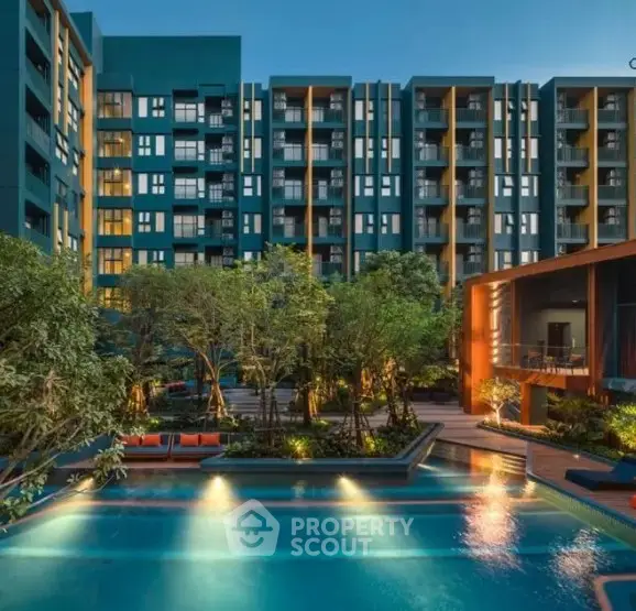 Luxurious modern apartment complex with stunning pool and lush greenery.