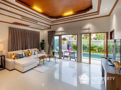 Luxurious living room with pool view and elegant decor in tropical villa