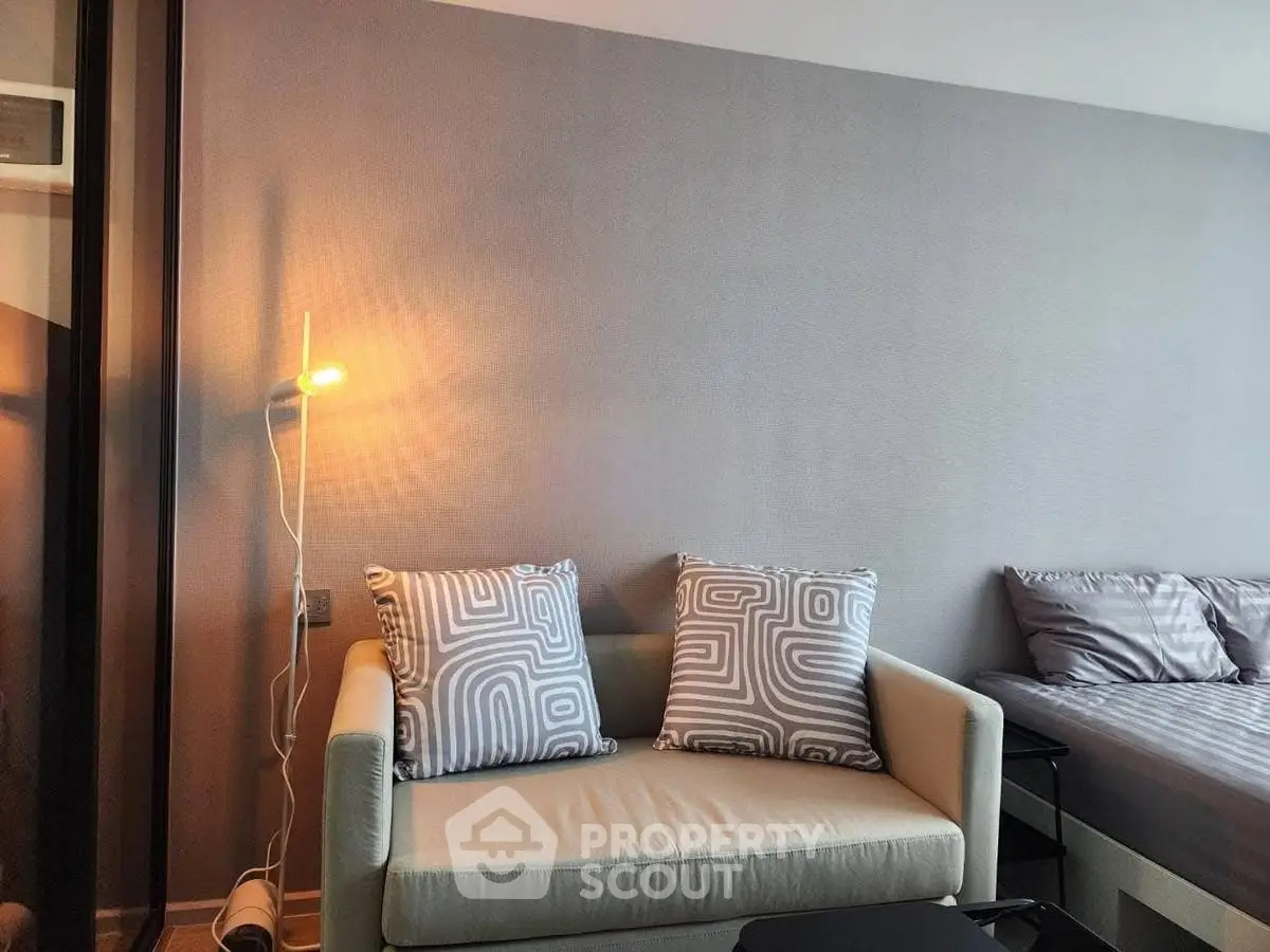 Modern living room with cozy sofa and stylish decor in a contemporary apartment.