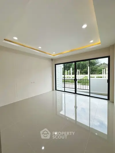 Spacious modern living room with large windows and glossy tile flooring.