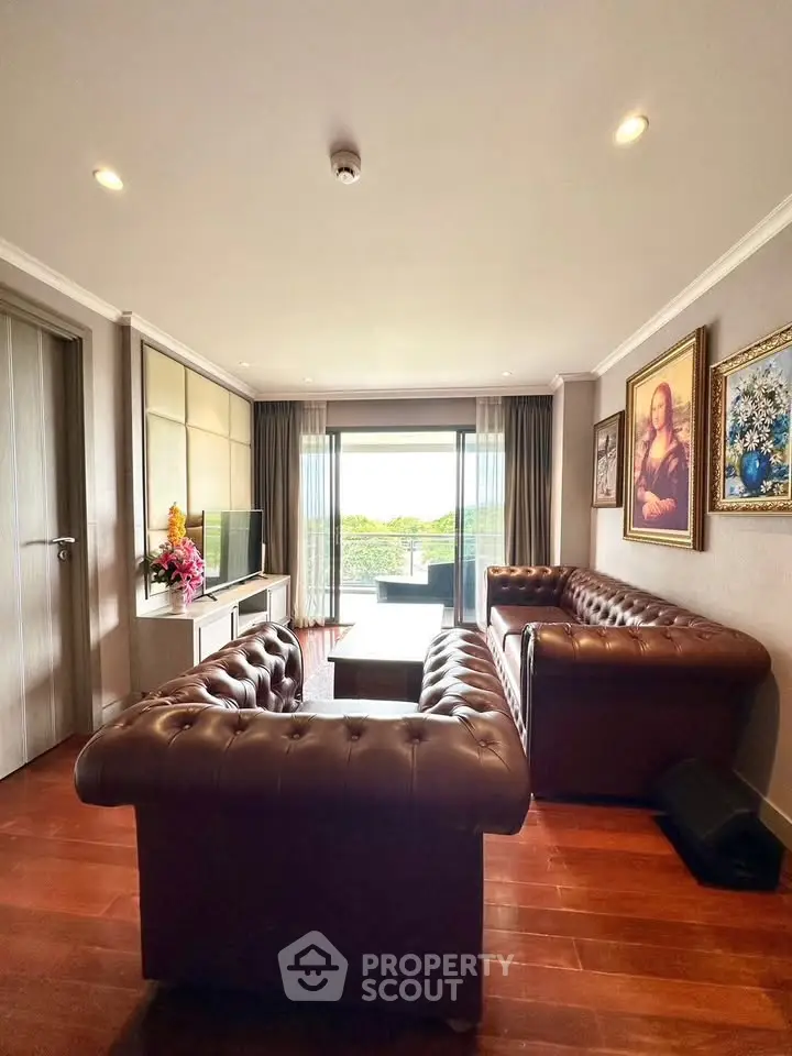 Luxurious living room with leather sofas and balcony view in modern apartment