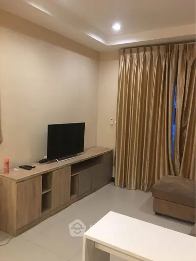 Cozy living room with modern TV stand and elegant curtains